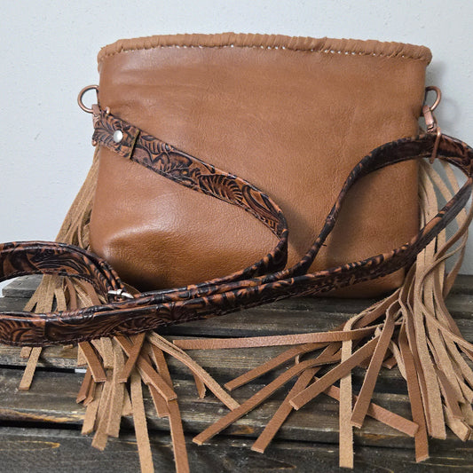 Back of Small Buckle Bag in whiskey smooth leather with fringe and embossed shoulder strap