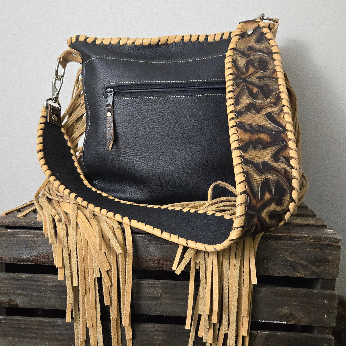 Black leather back of western bag with exterior zippered pocket