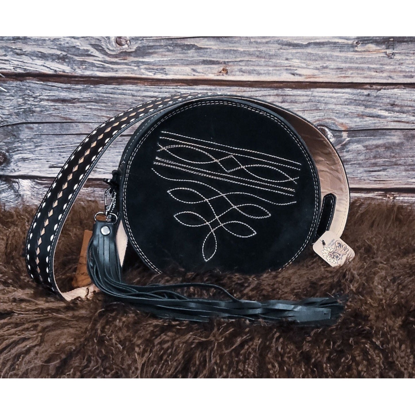 Midnight Rose hand-tooled western leather round bag with rose scroll tooling and black suede back back view