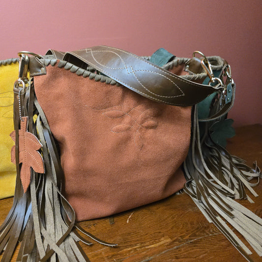 Rust suede fringe shoulder bag with gunslinger-stitched strap and matching tassel