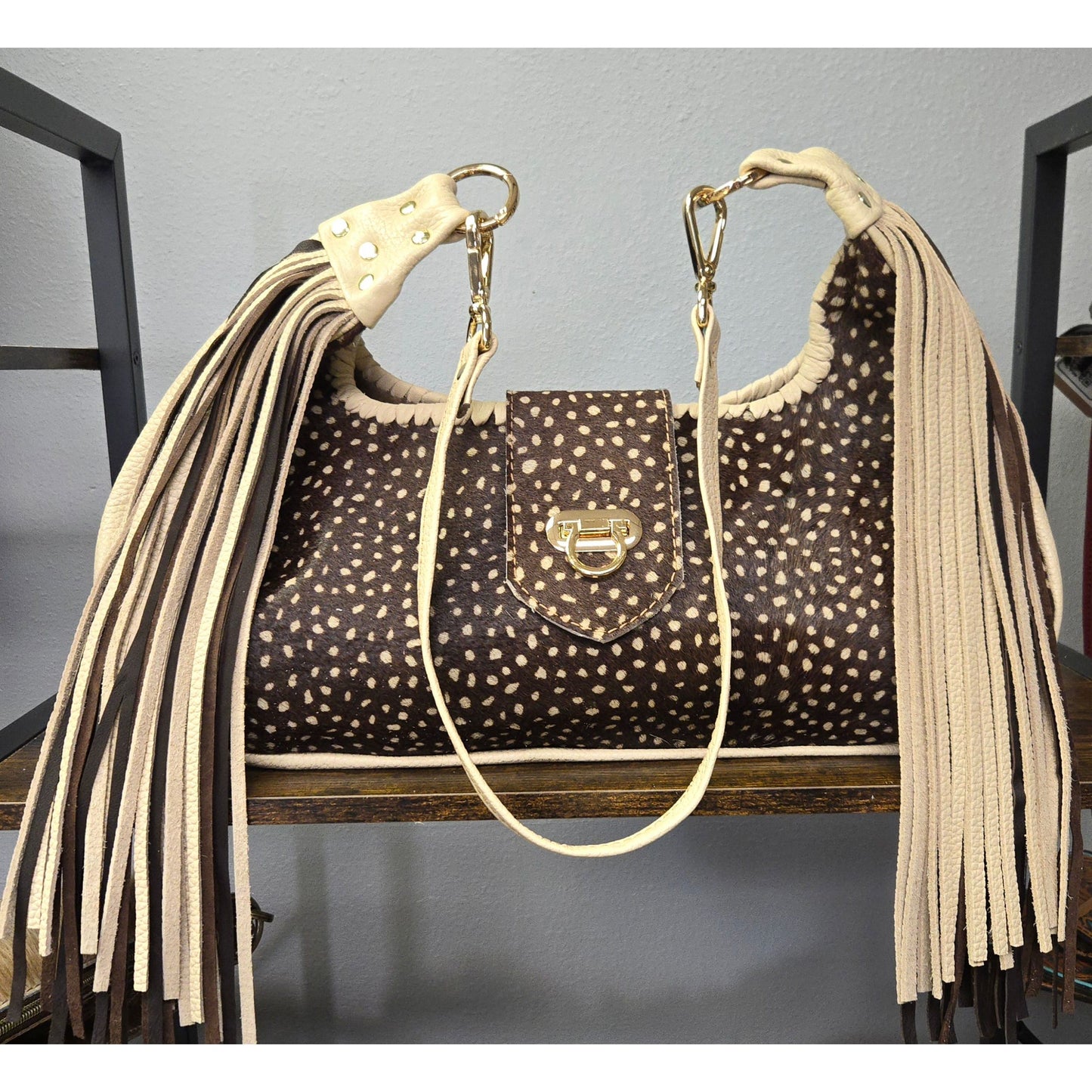 Luxury Stenciled Cowhide Handbag with Fringe and Gold Accents
