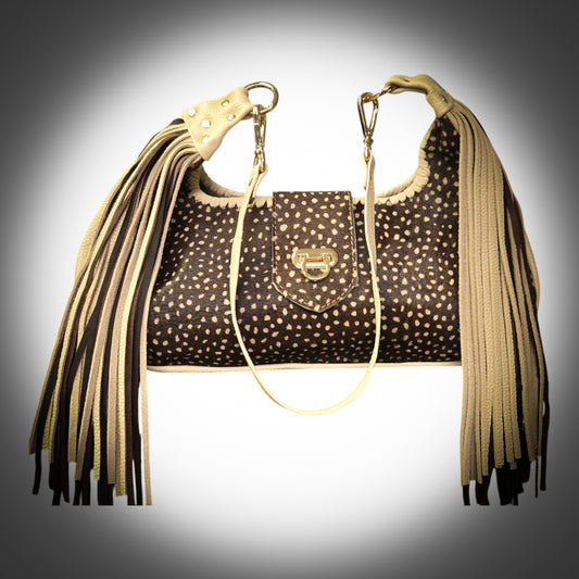 Luxury Stenciled Cowhide Handbag with Fringe and Gold Accents