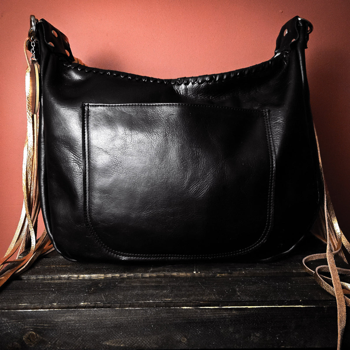 Back of copper acid-wash hobo bag with exterior slip pocket