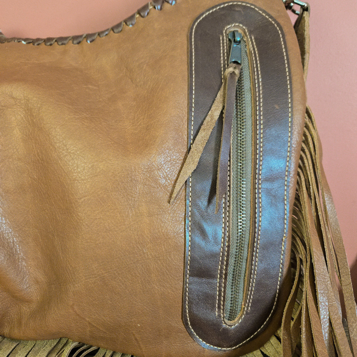 Back of western shoulder bag with vertical zippered concealed-carry pocket