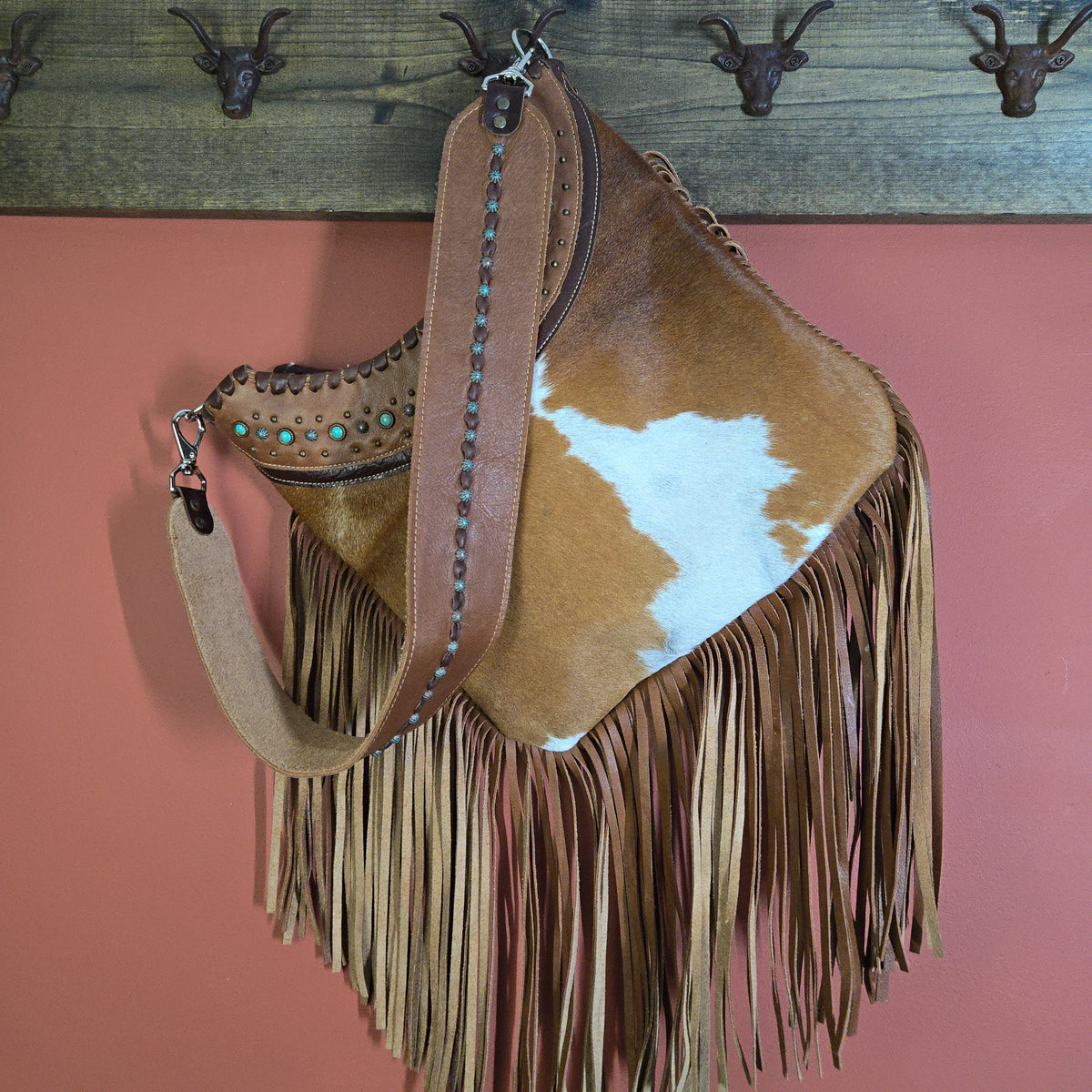 Brown-and-white hair-on-hide shoulder bag with hand-cut leather fringe