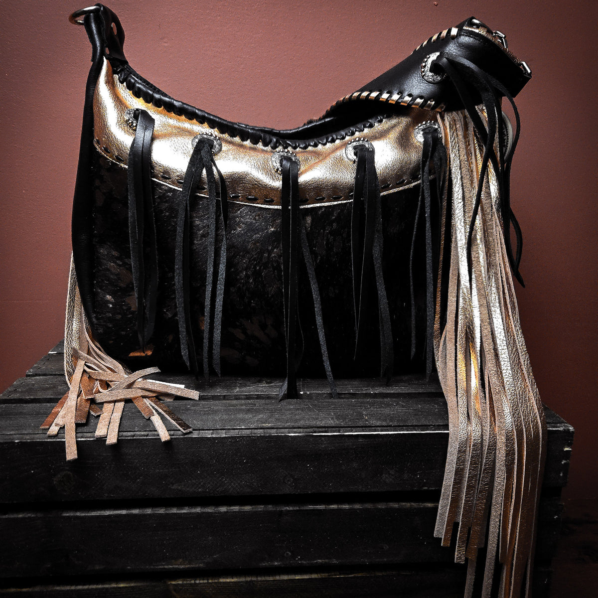 Copper hair-on-hide bag with concho details and hand-cut leather fringe
