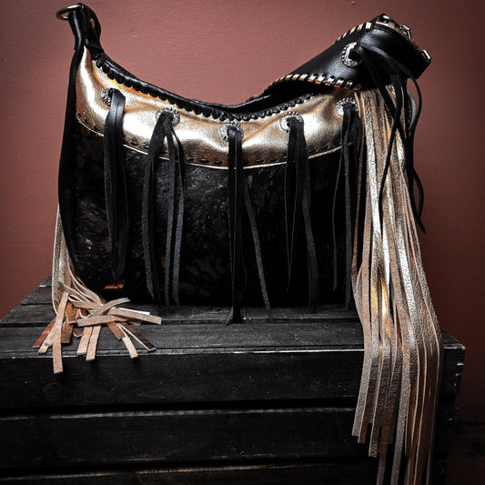 Copper hair-on-hide bag with concho details and hand-cut leather fringe