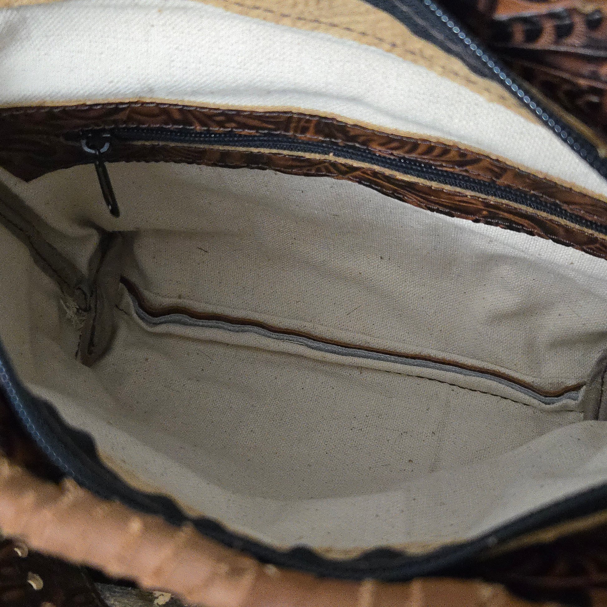 Fully lined interior of Small Buckle Bag with zipper pocket and canvas lining.