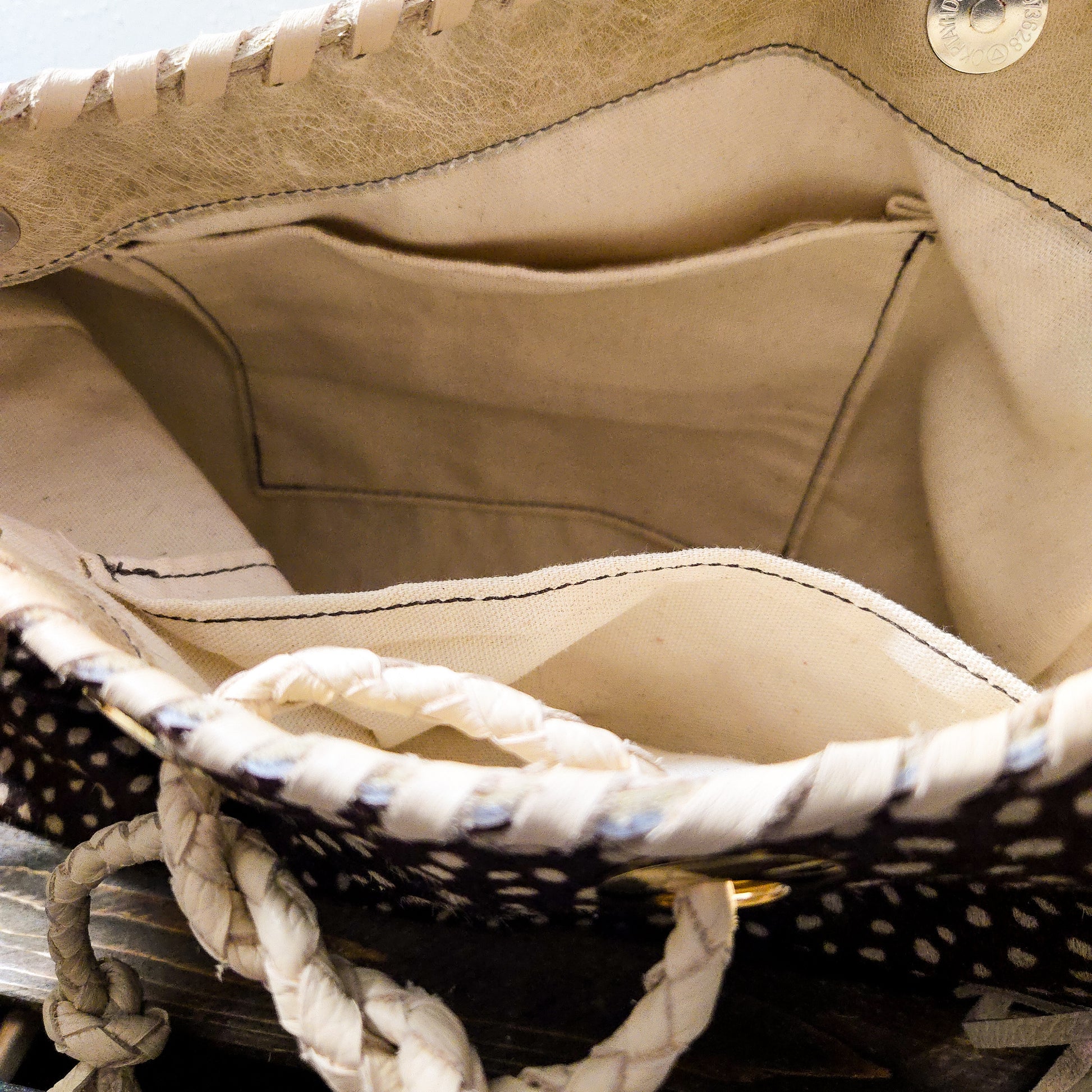 Interior of Uptown Cowgirl hair-on-hide leather bag showing lined compartment and inside pocket