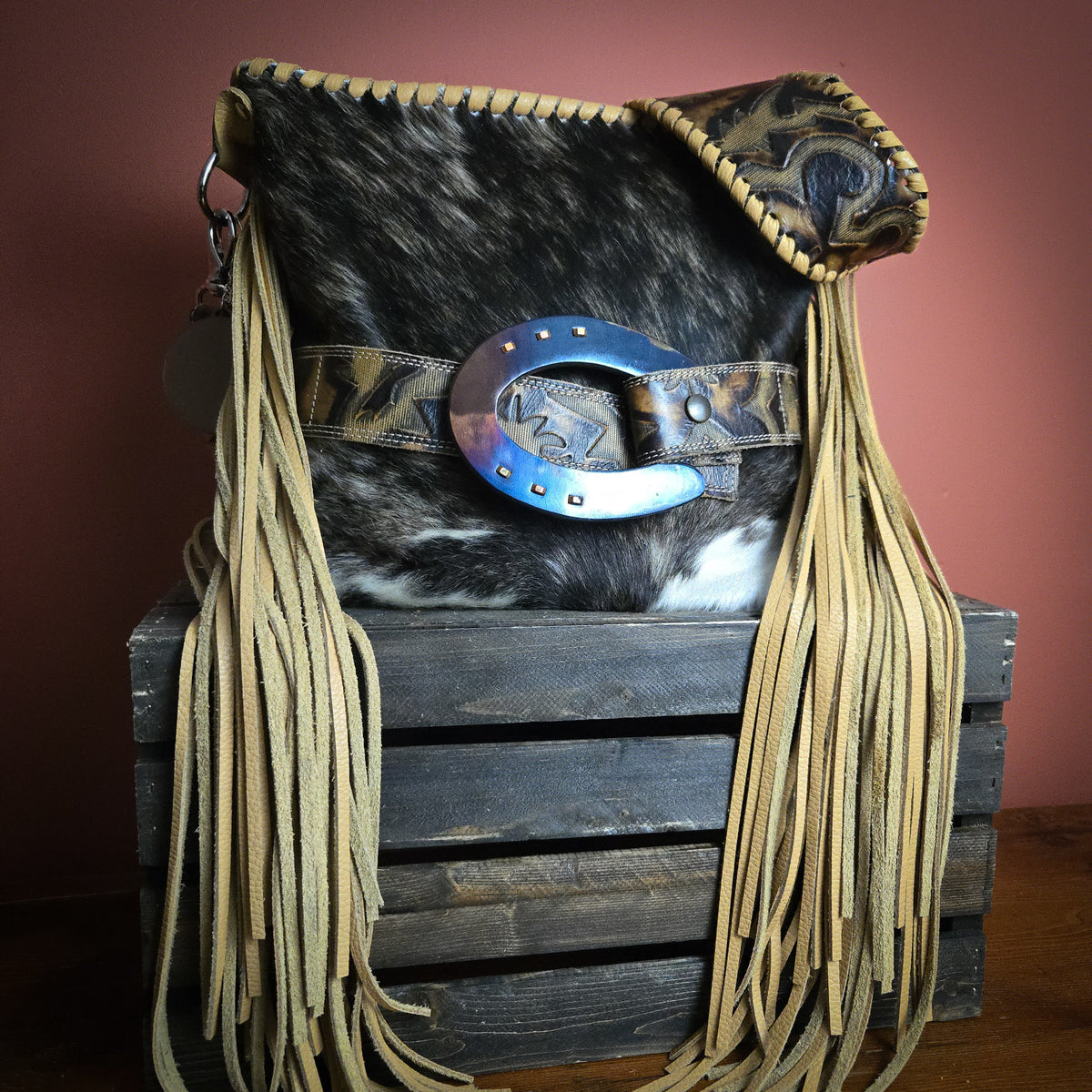 Brindle hair-on-hide fringe bag designed for a customer’s trophy buckle