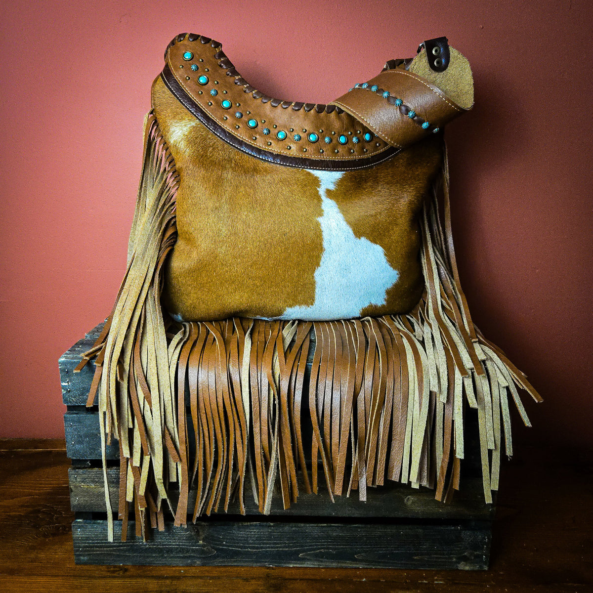 Studded western leather bag with turquoise-colored accents