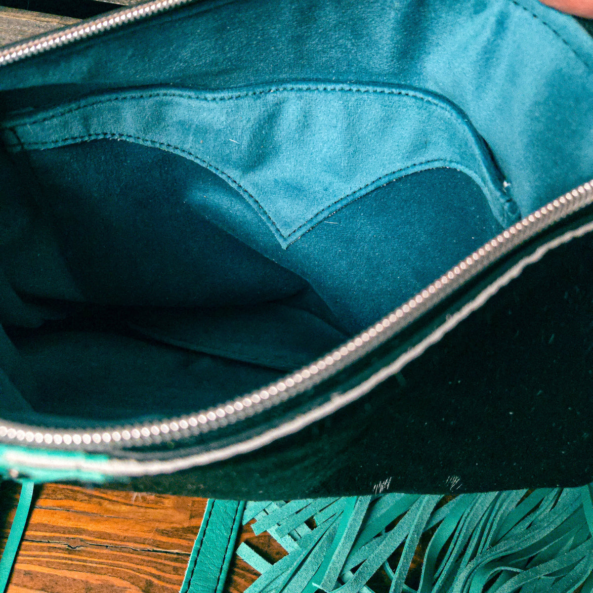 Turquoise velvet lining inside handcrafted leather shoulder bag