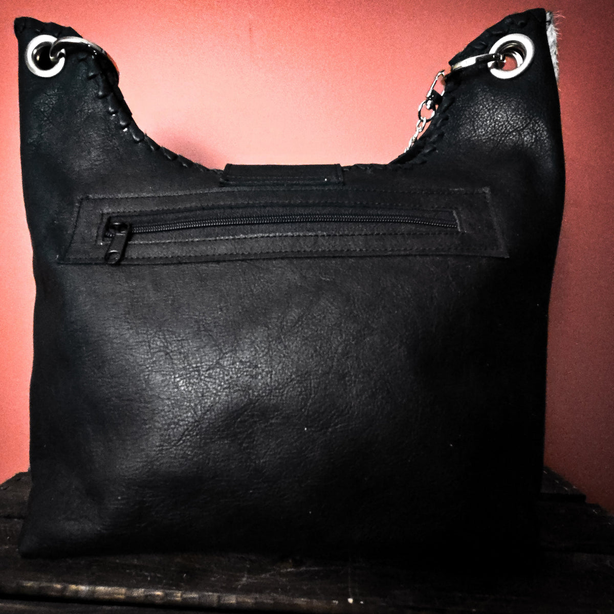 Black leather back of Uptown Cowgirl bag with exterior zippered pocket