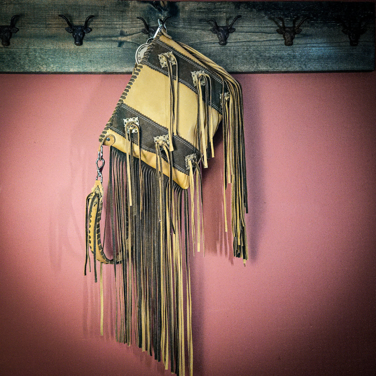 Wheat leather bag with hand-laced edge and top zipper closure
