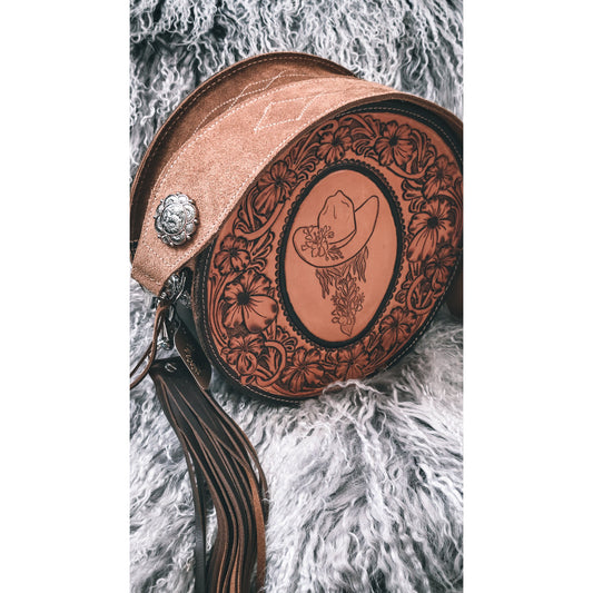 Wildflower Cowgirl 124J hand-tooled round leather bag with floral cowgirl linework and suede shoulder strap