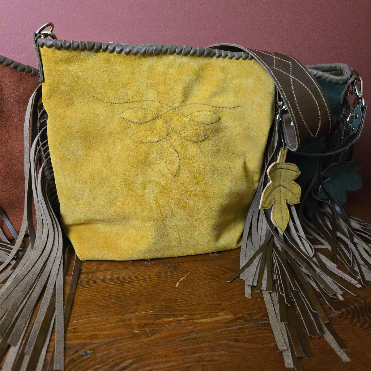 Goldenrod suede fringe bag with matching leather leaf-and-fringe tassel