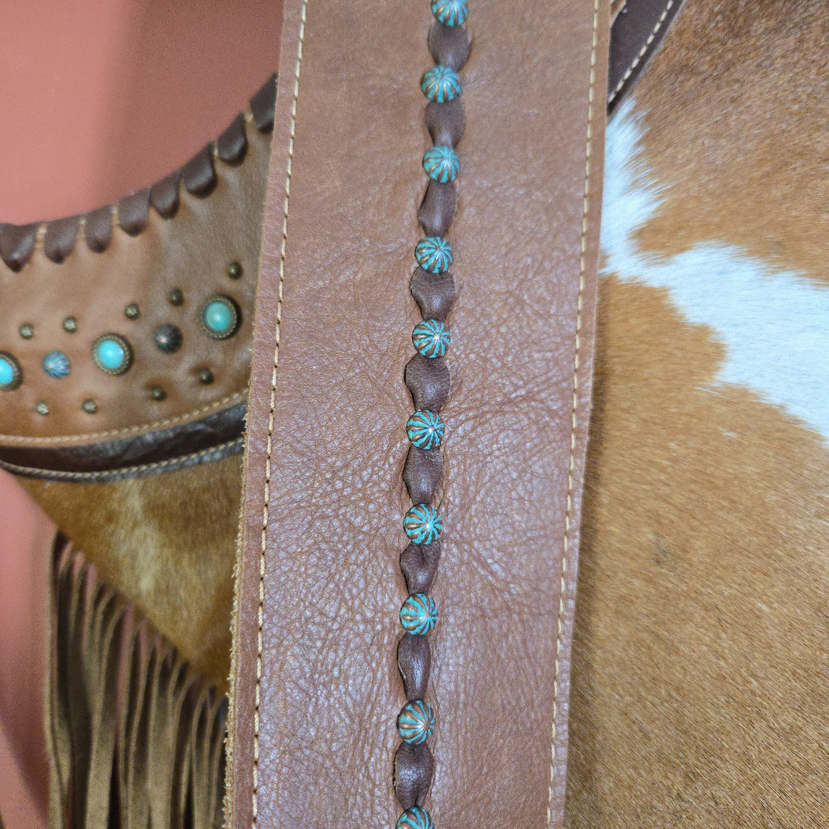 Hair-on-hide shoulder bag with 32-inch decorated leather strap